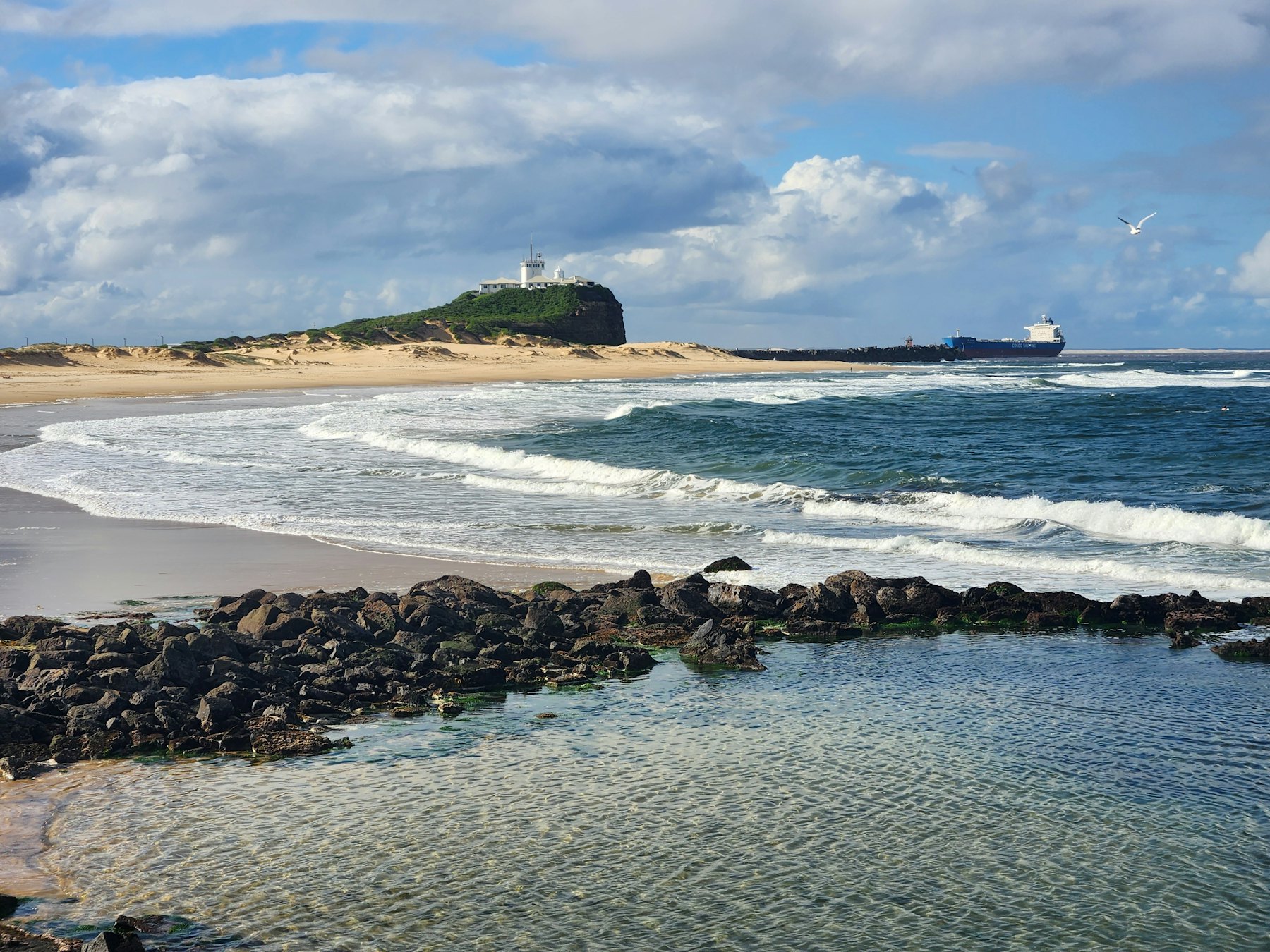 A beach and lighthouse on the Newcastle coastline, New South Wales